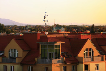 Dachy budynków osiedla mieszkaniowego, maszt radiowo telewizyjny, internet.