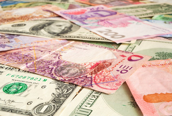 Cash money from various countries (Dollar, Qatari riyal, hryvnia). Exchange business concept background