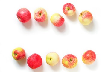 A border of red ripe apples on a white background. Autumn harvest