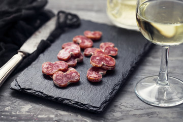 spanish sausage fuet on black ceramic board