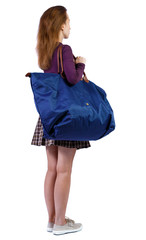 Back view of a woman with blue bag.