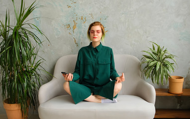 Meditation with a phone in his hands, deep breathing. Mobile meditation application. Concept young...