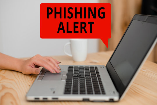 Text sign showing Phishing Alert. Business photo showcasing aware to fraudulent attempt to obtain sensitive information woman laptop computer smartphone mug office supplies technological devices