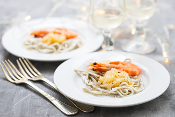 Traditional Spanish food. Gulas with oil and shrimp on white plate.
