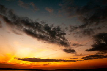 Beautiful colors during sunset. Clouds of golden tones over the blue sky.