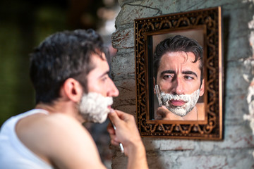 Serious boy shaving his beard