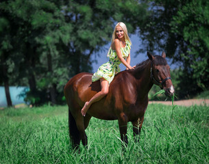 Woman and horse, green field, yellow dress