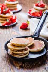 Cooking pancakes with fresh summer strawberries
