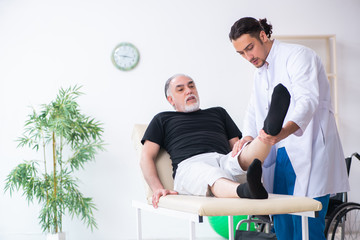 Fototapeta premium Old injured man visiting young doctor