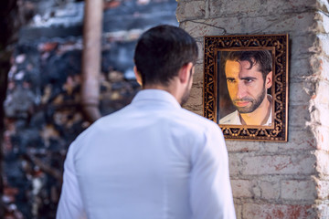 Man looks in the mirror.