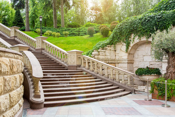 granite staircase with stone railings and balustrades with a wall rustic design in the background...