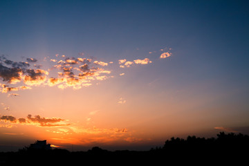 Beautiful colors during sunset. Clouds of golden tones over the blue sky.