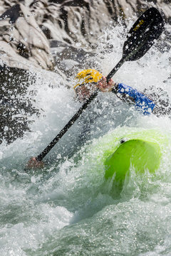 New Zealand, Murchison. A man paddles a kayak down a rapid on the Matakitaki River.