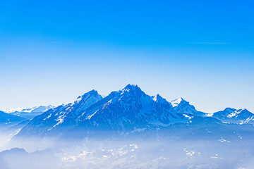 Majestic unique misty blue alpine skyline view panorama of Mount Pilatus and blue sky, Lucerne, Switzerland.