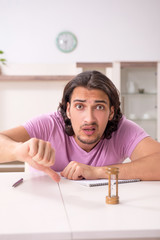 Young male student preparing for exams at home