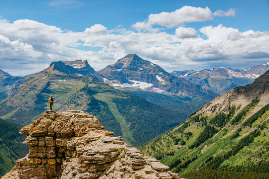 A woman admires the view on the loop trail from Two Medicine over Dawson Pass, Glacier National Park, Montana, USA.