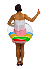 Back view of African American woman on the beach with inflatable