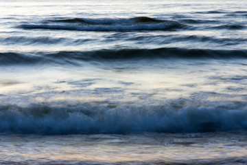 Fototapeta premium small waves in the sea during sunset.