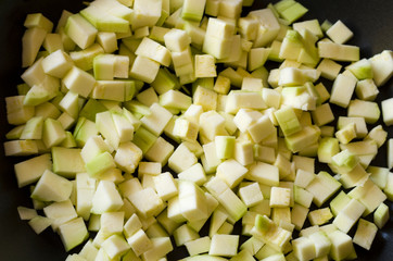 light green diced zucchini, close up view