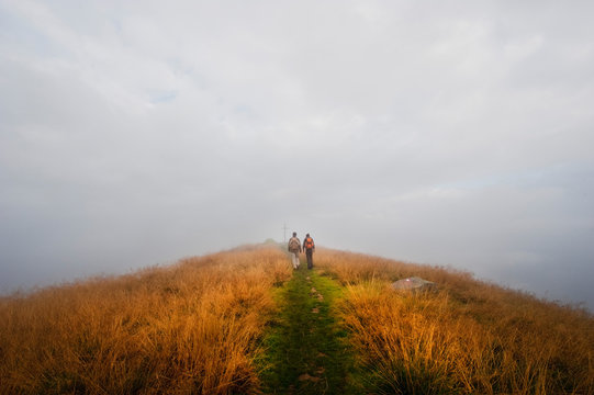 Austria, Styria, Man and woman walking on way to summit at Reiteralm