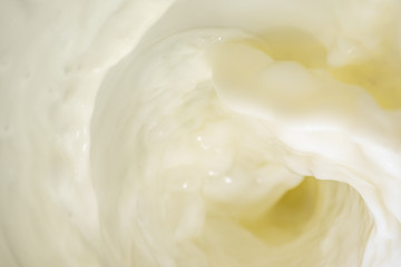 Bright background with pouring milk is macro