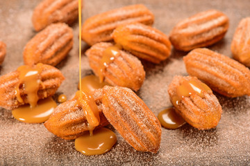 Dulce de leche churro on wooden background