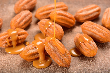 Dulce de leche churro on wooden background