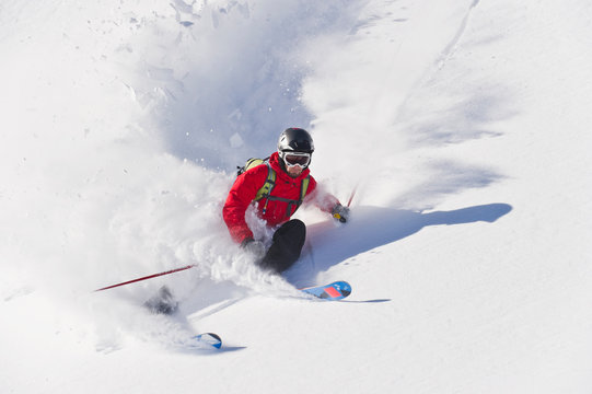 Austria, Zuers, Young man doing telemark skiing on Arlberg mountain - Powered by Adobe