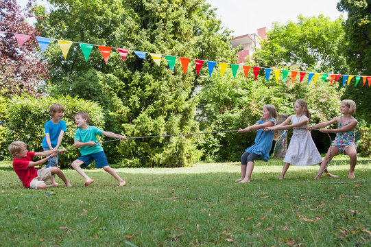 Children playing tug-of-war on a birthday party