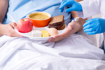 Male patient eating food in the hospital