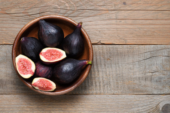 Fresh figs in wooden bowl top view