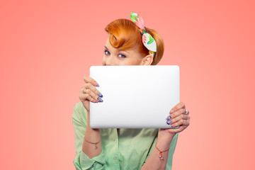 Student hiding behind laptop.