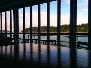 view to a headland and inlet through windows in a ferry terminal