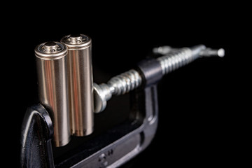 Batteries in the carpentry clamp. Energy compressed in the workshop.