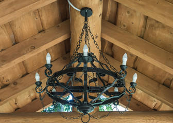 Round black wrought iron chandelier with bulbs weighs in summer house