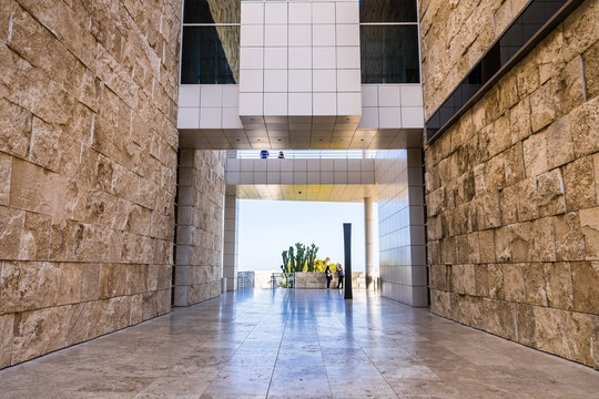 June 8, 2018 Los Angeles / CA / USA - Walking Corridor Between Travertine Covered Walls And Below An Aerial Walkway Connecting Buildings At The Getty Center;