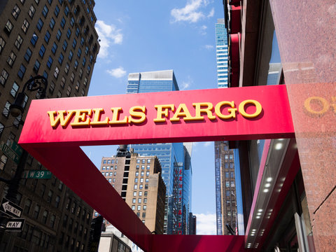 New York, New York, USA - May 31, 2012: A Wells Fargo sign at a Wells Fargo location in Midtown Manhattan. Manhattan buildings can be seen in the background.