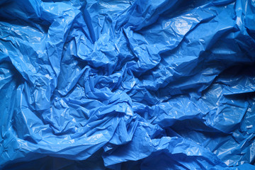 Blue crumpled plastic garbage bag texture background. Waste recycle concept. Pattern of materials. 