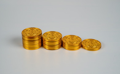Bitcoin coins from high to low in a down going chart