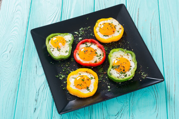 Yellow , red and green pepper with fried eggs