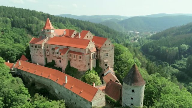 Aerial View of Fabulous Pernstejn Castle (hrad Pernstejn) in Forest on a rock in Moravia, Czech Republic, Europe. 4K Drone Panning shot