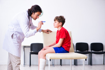 Leg injured boy visiting young doctor traumatologist