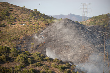 Helicopters putting out a forest fire in the Sierra Bermeja mountains in Estepona, Spain