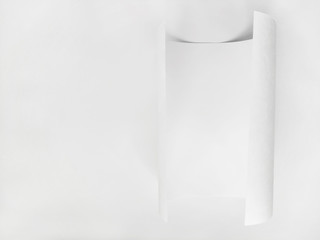 White folded sheet of paper is on a white textured background, whatman paper. Empty place. Copyspace, close up, mockup, isolated. Clear paper