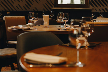 tableware Glasses, flower fork, knife served for dinner in restaurant with cozy interior