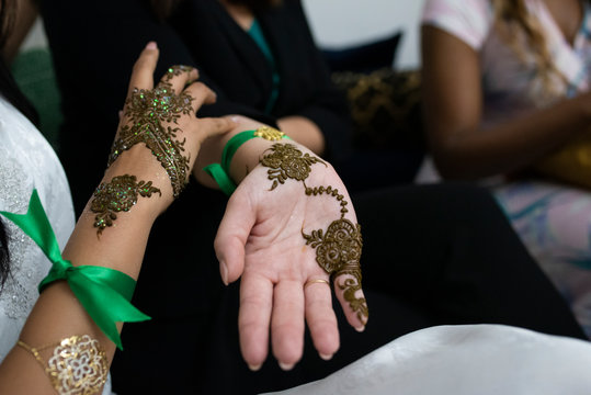 Closeup of moroccan women hands with henna decoration.