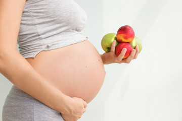 pregnant woman with fruit in her hands. Vitamins for pregnant women. Vegetarianism. Useful products for pregnant women. Diet during pregnancy.