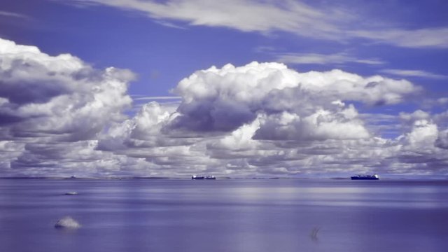 4k long exposure infrared timelapse of sea with ships and changing summer clouds