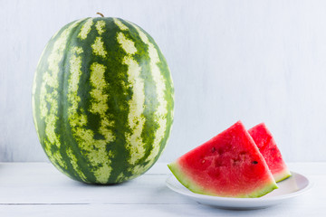Watermelon on natural white background. Whole watermelon on wooden background. Healthy food for vegan. Copy space