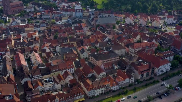 Aerial view of the city Eberbach in Germany.  Camera pans left along the city, rotates right toward the Neckar River.